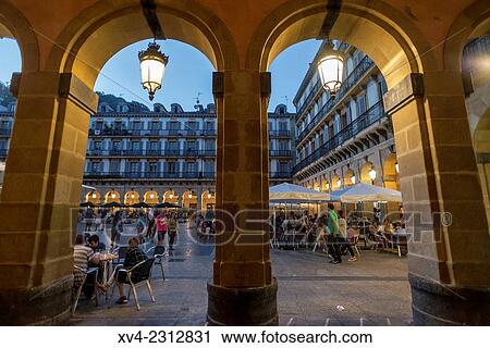 Stock Image - Constitución Square. Old town of San Sebastián by night. Donostia, Basque Country, Spain.. Fotosearch