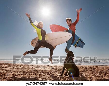 Stock Photo - Couple of crazy surfers. El Palmar, Tarifa, Cadiz, Costa de la Luz, Andalusia, Southern Spain.. Fotosearch