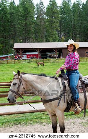 Cowgirl (Wrangler) on horse at Averill´s Flathead Lake Lodge, a dude ranch near Kalispell, Montana, United States. View Large Photo Image Stock Photography - Cowgirl (Wrangler) on horse at Averill´s Flathead Lake Lodge, a dude ranch near Kalispell, Montana, United States.. Fotosearch