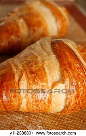 Stock Photo - croissants on baking mat fresh from the oven.. Fotosearch