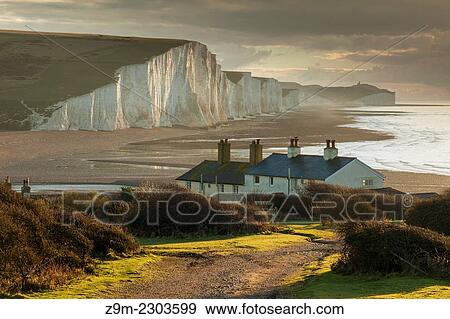 Stock Photo - Early winter morning at Coastguard Cottages and Seven Sister cliffs, East Sussex, England.. Fotosearch