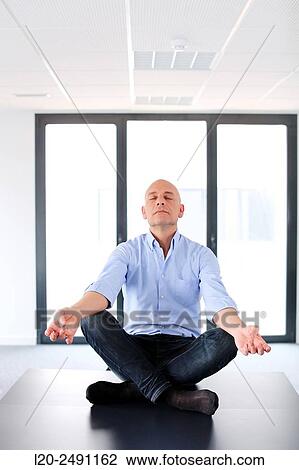 Executive doing Yoga. Empty office. Meeting room. View Large Photo Image Stock Image - Executive doing Yoga. Empty office. Meeting room.. Fotosearch
