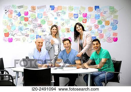 Picture - Executives at meeting table. Office. Coworking.. Fotosearch