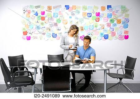 Executives at meeting table. Office. Coworking. View Large Photo Image Stock Photo - Executives at meeting table. Office. Coworking.. Fotosearch