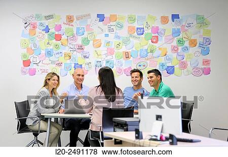Executives at meeting table. Office. Coworking. View Large Photo Image Stock Photo - Executives at meeting table. Office. Coworking.. Fotosearch