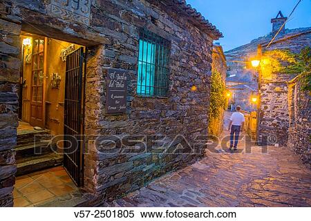 Stock Photography - Facade of restaurant and typical street, night view. Patones de Arriba, Madrid province, Spain.. Fotosearch