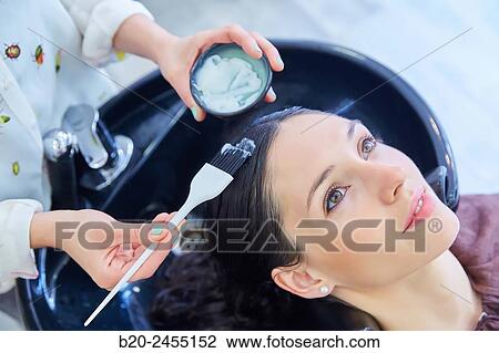 Hairdresser applying a hair treatment to a woman. Hairdressing salon and Beauty Clinic. View Large Photo Image Stock Image - Hairdresser applying a hair treatment to a woman. Hairdressing salon and Beauty Clinic.. Fotosearch