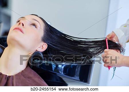 Hairdresser combing the hair of a woman. Hairdressing salon and Beauty Clinic. View Large Photo Image Picture - Hairdresser combing the hair of a woman. Hairdressing salon and Beauty Clinic.. Fotosearch