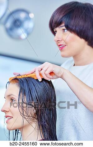 Hairdresser combing the hair of a woman. Hairdressing salon and Beauty Clinic. View Large Photo Image Stock Image - Hairdresser combing the hair of a woman. Hairdressing salon and Beauty Clinic.. Fotosearch