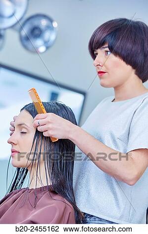 Hairdresser combing the hair of a woman. Hairdressing salon and Beauty Clinic. View Large Photo Image Stock Image - Hairdresser combing the hair of a woman. Hairdressing salon and Beauty Clinic.. Fotosearch