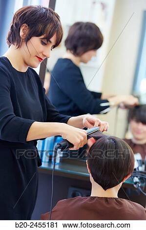 Hairdresser combing the hair of a woman. Hairdressing salon and Beauty Clinic. View Large Photo Image Stock Image - Hairdresser combing the hair of a woman. Hairdressing salon and Beauty Clinic.. Fotosearch