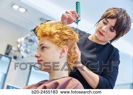 Hairdresser combing the hair of a woman. Hairdressing salon and Beauty Clinic. View Large Photo Image Stock Image - Hairdresser combing the hair of a woman. Hairdressing salon and Beauty Clinic.. Fotosearch