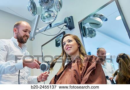 Hairdresser combing the hair of a woman. Hairdressing salon and Beauty Clinic. View Large Photo Image Stock Photo - Hairdresser combing the hair of a woman. Hairdressing salon and Beauty Clinic.. Fotosearch