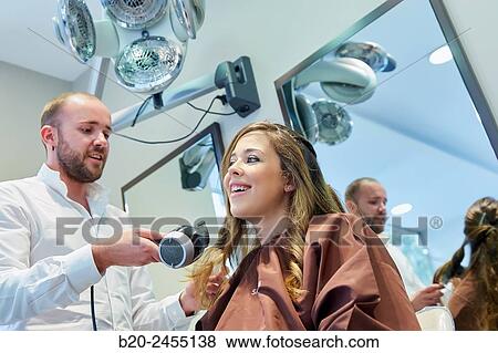 Hairdresser combing the hair of a woman. Hairdressing salon and Beauty Clinic. View Large Photo Image Stock Photo - Hairdresser combing the hair of a woman. Hairdressing salon and Beauty Clinic.. Fotosearch