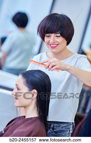 Hairdresser combing the hair of a woman. Hairdressing salon and Beauty Clinic. View Large Photo Image Stock Photo - Hairdresser combing the hair of a woman. Hairdressing salon and Beauty Clinic.. Fotosearch