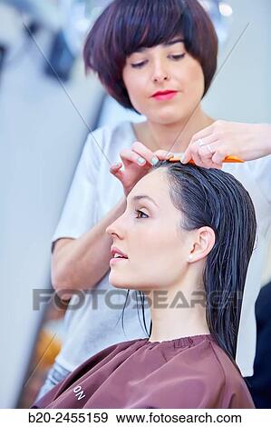 Hairdresser combing the hair of a woman. Hairdressing salon and Beauty Clinic. View Large Photo Image Stock Photo - Hairdresser combing the hair of a woman. Hairdressing salon and Beauty Clinic.. Fotosearch
