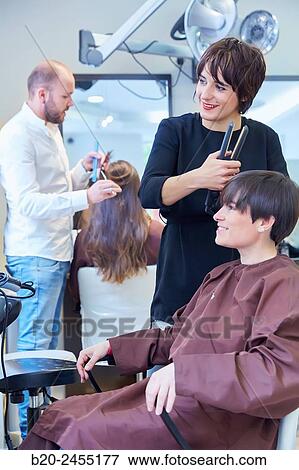Hairdresser combing the hair of a woman. Hairdressing salon and Beauty Clinic. View Large Photo Image Stock Photo - Hairdresser combing the hair of a woman. Hairdressing salon and Beauty Clinic.. Fotosearch