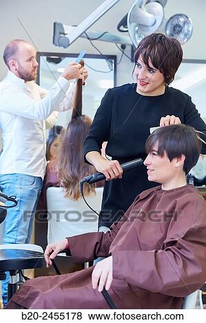 Hairdresser combing the hair of a woman. Hairdressing salon and Beauty Clinic. View Large Photo Image Stock Photo - Hairdresser combing the hair of a woman. Hairdressing salon and Beauty Clinic.. Fotosearch
