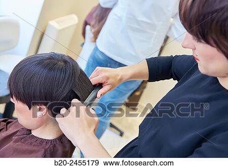 Hairdresser combing the hair of a woman. Hairdressing salon and Beauty Clinic. View Large Photo Image Stock Photo - Hairdresser combing the hair of a woman. Hairdressing salon and Beauty Clinic.. Fotosearch