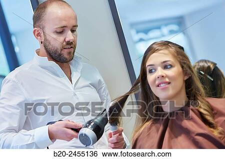 Hairdresser combing the hair of a woman. Hairdressing salon and Beauty Clinic. View Large Photo Image Stock Photograph - Hairdresser combing the hair of a woman. Hairdressing salon and Beauty Clinic.. Fotosearch