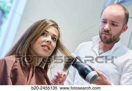 Hairdresser combing the hair of a woman. Hairdressing salon and Beauty Clinic. View Large Photo Image Stock Photography - Hairdresser combing the hair of a woman. Hairdressing salon and Beauty Clinic.. Fotosearch