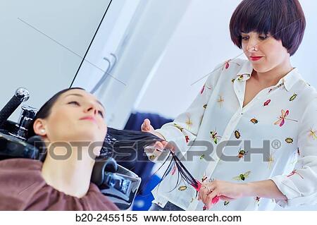 Hairdresser combing the hair of a woman. Hairdressing salon and Beauty Clinic. View Large Photo Image Stock Photography - Hairdresser combing the hair of a woman. Hairdressing salon and Beauty Clinic.. Fotosearch