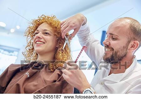 Hairdresser cutting the hair of a woman. Hairdressing salon and Beauty Clinic. View Large Photo Image Stock Photo - Hairdresser cutting the hair of a woman. Hairdressing salon and Beauty Clinic.. Fotosearch