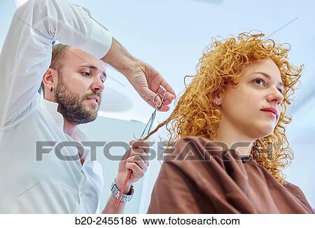Hairdresser cutting the hair of a woman. Hairdressing salon and Beauty Clinic. View Large Photo Image Stock Photograph - Hairdresser cutting the hair of a woman. Hairdressing salon and Beauty Clinic.. Fotosearch