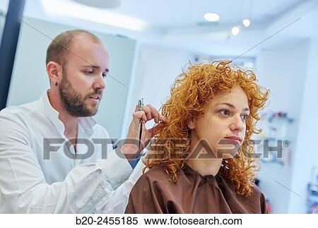 Hairdresser cutting the hair of a woman. Hairdressing salon and Beauty Clinic. View Large Photo Image Stock Photography - Hairdresser cutting the hair of a woman. Hairdressing salon and Beauty Clinic.. Fotosearch