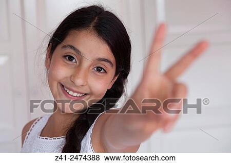 Happy teenage girl with V sign gesture. View Large Photo Image Stock Photo - Happy teenage girl with V sign gesture.. Fotosearch
