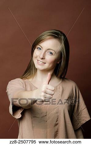 Happy young woman showing a thumbs up gesture. View Large Photo Image Stock Photography - Happy young woman showing a thumbs up gesture.. Fotosearch