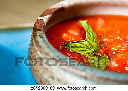 Stock Photo - Homemade tomatoes soup with fresh basil is a healthy option for a gluten-free diet.. Fotosearch