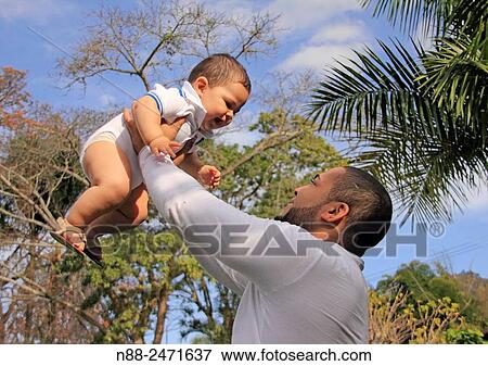 Stock Photo - Latin american father and kid. Fotosearch
