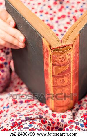 Little girl in dress reading in an old book. Conceptual image of learning to read at an early age. View Large Photo Image Stock Image - Little girl in dress reading in an old book. Conceptual image of learning to read at an early age.. Fotosearch