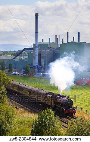 Picture - LMS Jubilee Class 45699 Galatea passing British Gypsum, plaster and plasterboard plant. Kirkby Thore Eden Valley, Cumbria, Settle to Carlisle Railway Line, England, UK.. Fotosearch