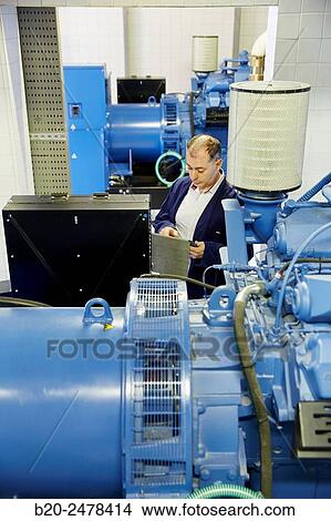 Picture - Maintenance worker, Cogeneration engine, Electric generator, uninterrupted electric service, Hospital Donostia, San Sebastian, Gipuzkoa, Basque Country, Spain. Fotosearch