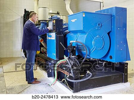 Stock Image - Maintenance worker, Cogeneration engine, Electric generator, uninterrupted electric service, Hospital Donostia, San Sebastian, Gipuzkoa, Basque Country, Spain. Fotosearch