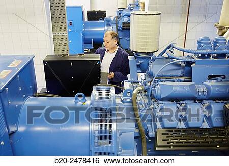 Stock Photograph - Maintenance worker, Cogeneration engine, Electric generator, uninterrupted electric service, Hospital Donostia, San Sebastian, Gipuzkoa, Basque Country, Spain. Fotosearch
