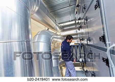 Stock Image - Maintenance worker, Installation of air conditioning, Ventilation air filters of the operating rooms, Hospital Donostia, San Sebastian, Gipuzkoa, Basque Country, Spain. Fotosearch