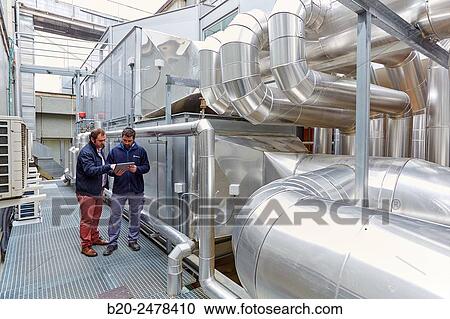 Stock Image - Maintenance worker, Installation of air conditioning, Ventilation air filters of the operating rooms, Hospital Donostia, San Sebastian, Gipuzkoa, Basque Country, Spain. Fotosearch