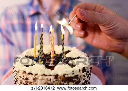 male hand lights the candles on the birthday cake. View Large Photo Image Stock Image - male hand lights the candles on the birthday cake.. Fotosearch