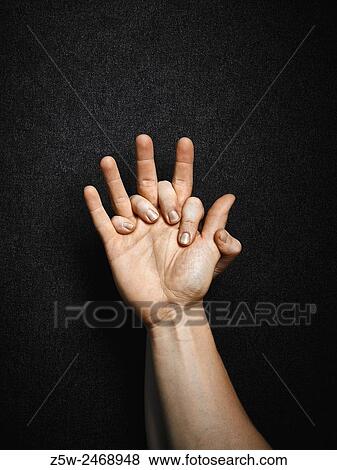 Stock Photo - Man and woman, hands connecting together, dark canvas background.. Fotosearch