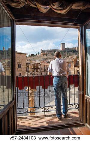 Man on a balcony. Peñaranda de Duero, Burgos province, Castilla Leon, Spain. View Large Photo Image Stock Image - Man on a balcony. Peñaranda de Duero, Burgos province, Castilla Leon, Spain.. Fotosearch