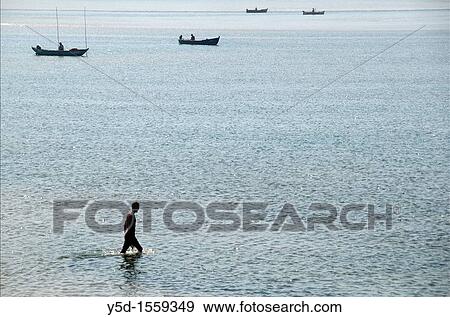 man walking in the water of Obidos Lagoon, Foz do Arelho, Slver Coast, Leiria district, Portugal, October View Large Photo Image Stock Photo - man walking in the water of Obidos Lagoon, Foz do Arelho, Slver Coast, Leiria district, Portugal, October. Fotosearch