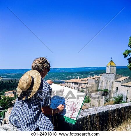 Middle aged woman drawing Aurel perched village, Vaucluse, Provence, France. View Large Photo Image Stock Photo - Middle aged woman drawing Aurel perched village, Vaucluse, Provence, France.. Fotosearch