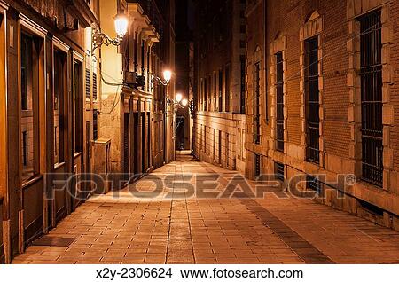 Narrow alley illuminated by street lamps at night, Madrid, Spain. View Large Photo Image Picture - Narrow alley illuminated by street lamps at night, Madrid, Spain.. Fotosearch
