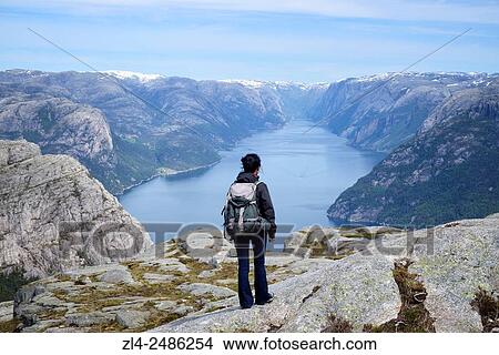 Picture - Norway, Rogaland, Lysefjord, hiker on the trail to Preikestolen (Pulpit Rock) 600m above the fjord, Model Released.. Fotosearch
