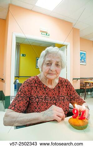 Old woman in a nursing home, celebrating her ninety first birthday, smiling and looking at the camera. View Large Photo Image Stock Image - Old woman in a nursing home, celebrating her ninety first birthday, smiling and looking at the camera.. Fotosearch