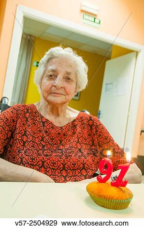 Old woman in a nursing home, celebrating her ninety first birthday, smiling and looking at the camera. View Large Photo Image Stock Photo - Old woman in a nursing home, celebrating her ninety first birthday, smiling and looking at the camera.. Fotosearch