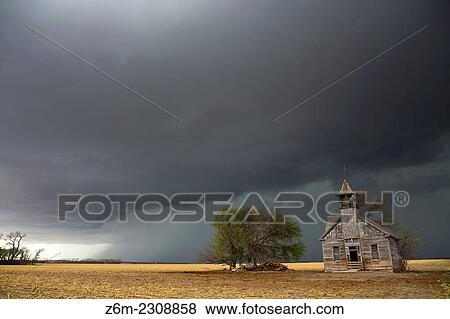Outflow behind a tornado warned supercell approaches an old weathered school house in eastern Nebraska. View Large Photo Image Stock Photo - Outflow behind a tornado warned supercell approaches an old weathered school house in eastern Nebraska.. Fotosearch